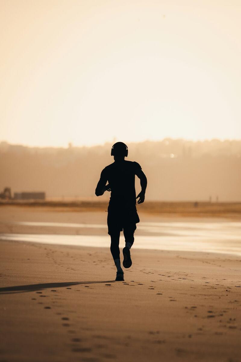 A runner on the beach at golden hour