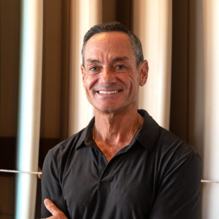 Portrait of Jeff Sternberg, smiling, arms crossed